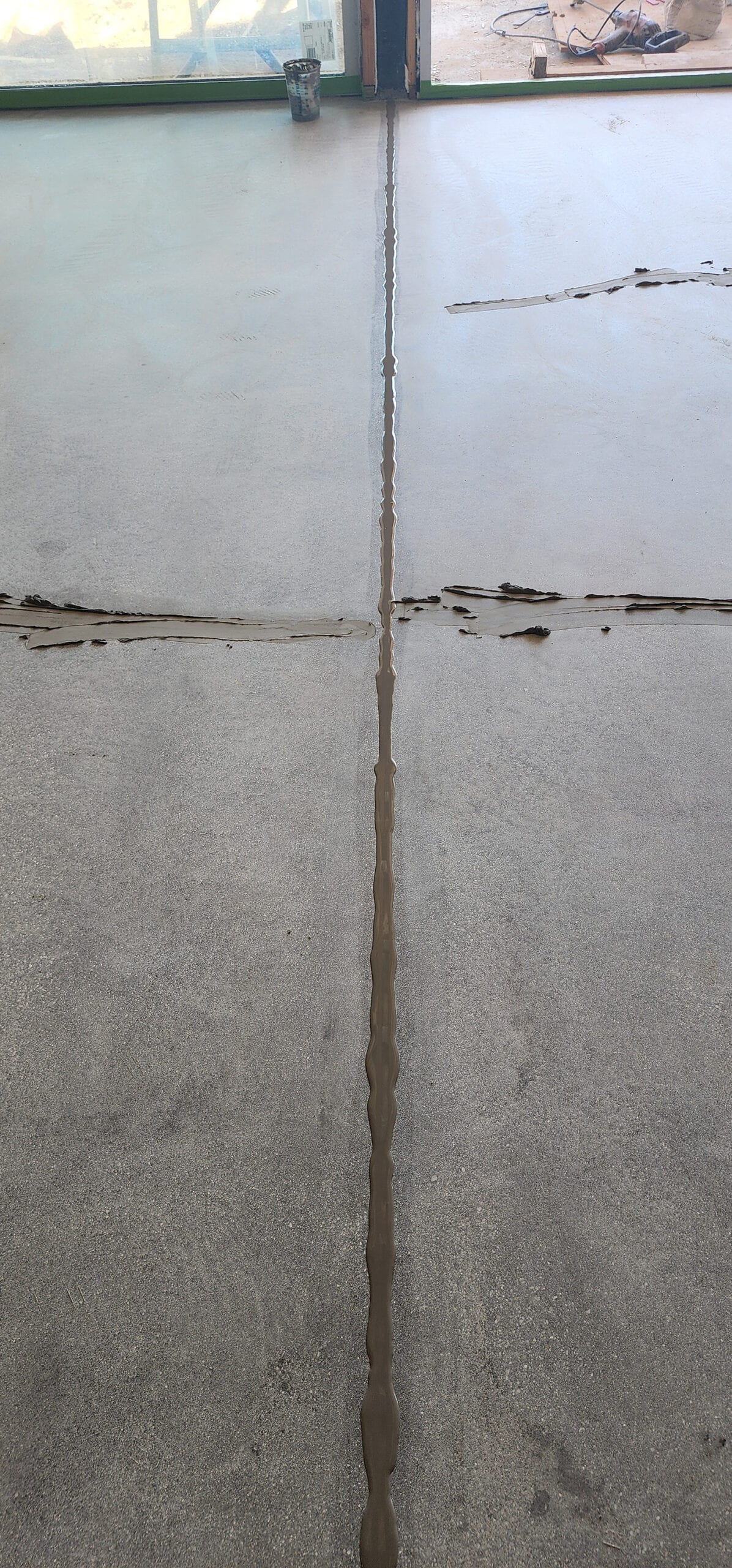 Semi-rigid filler being applied to a concrete control joint