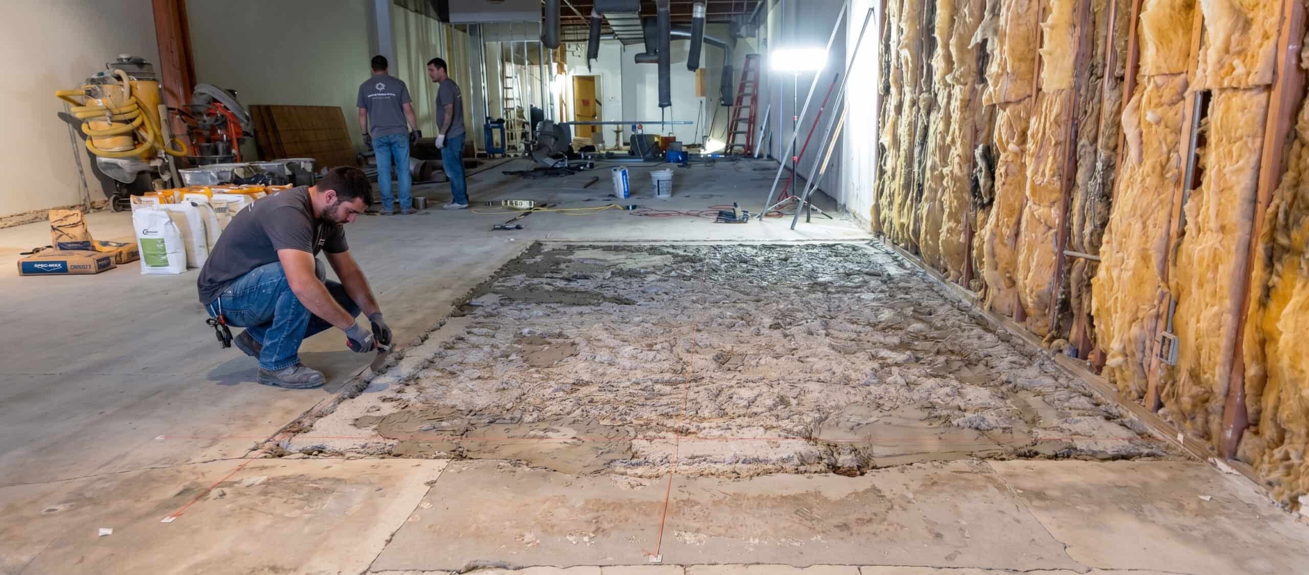 An IT'S SO CLEAN crew removing a damaged floor during a concrete restoration