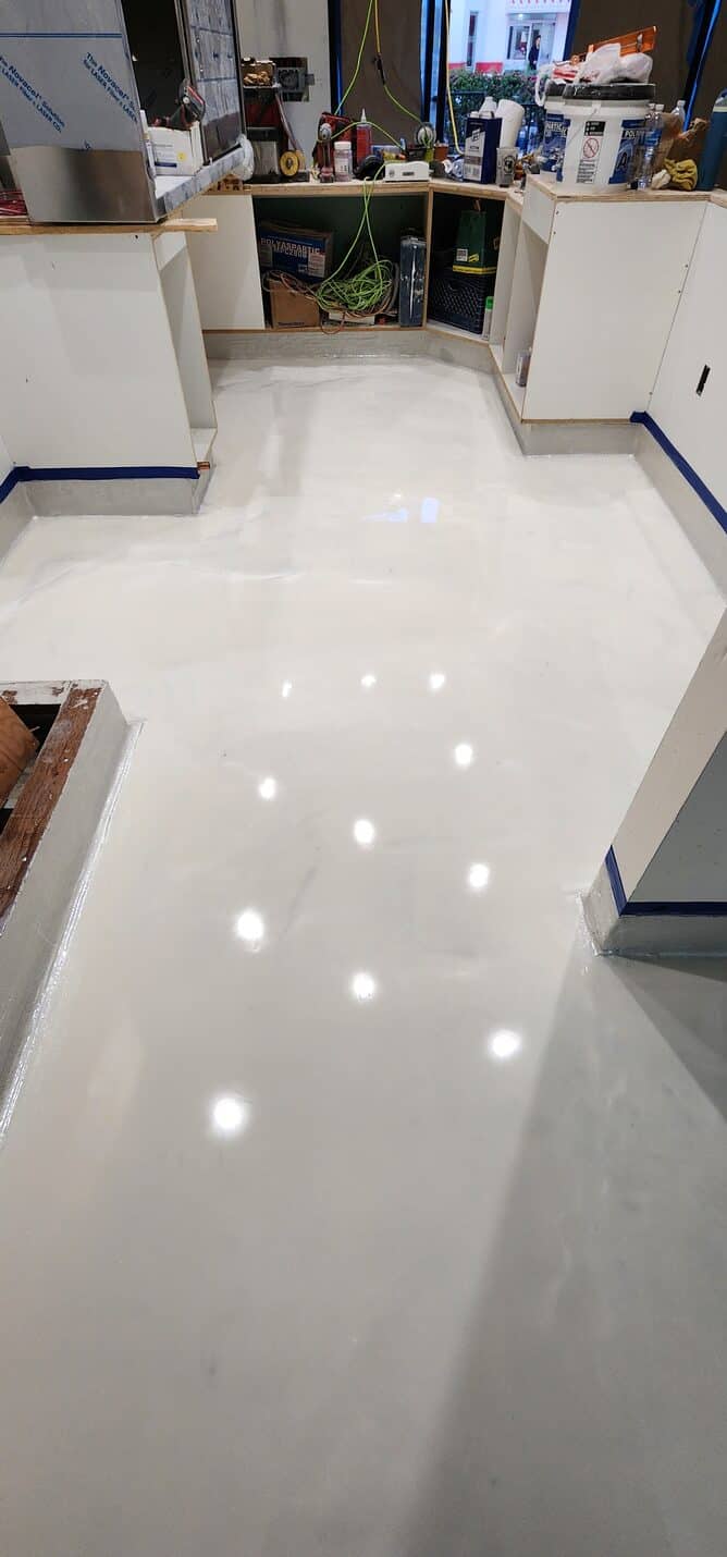 Two tone metallic floor meeting at the doorway