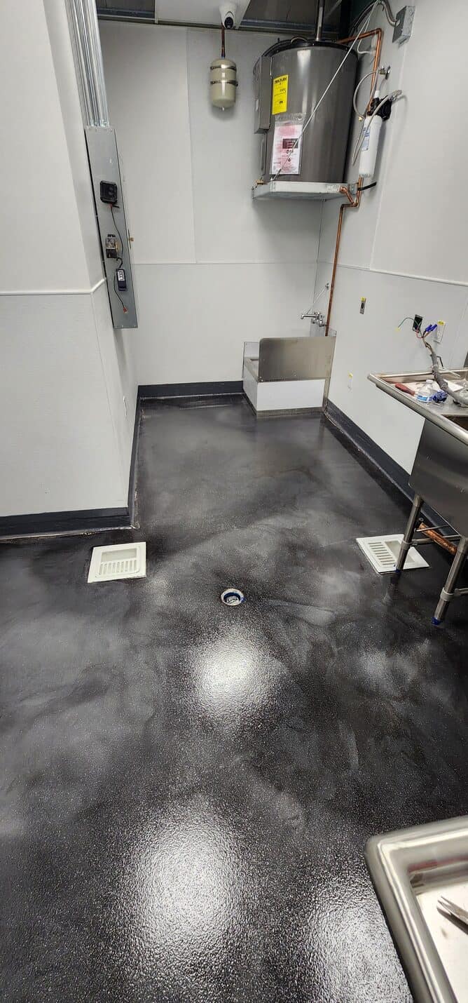 Bare concrete through the back corridor before work