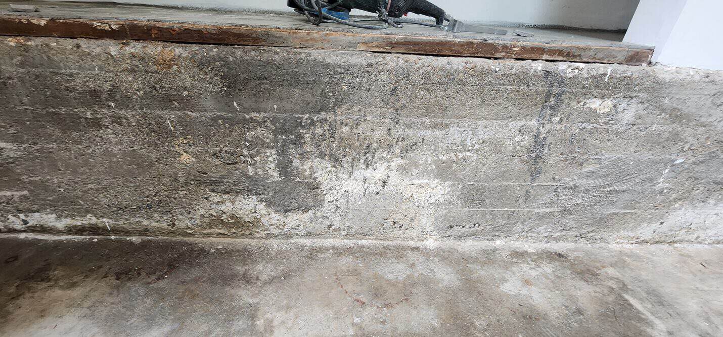 Rough concrete stem wall along the side of the ADU floor