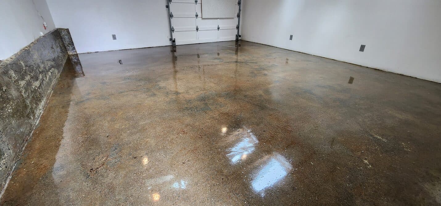 Satin clear epoxy floor reflecting light in the converted garage