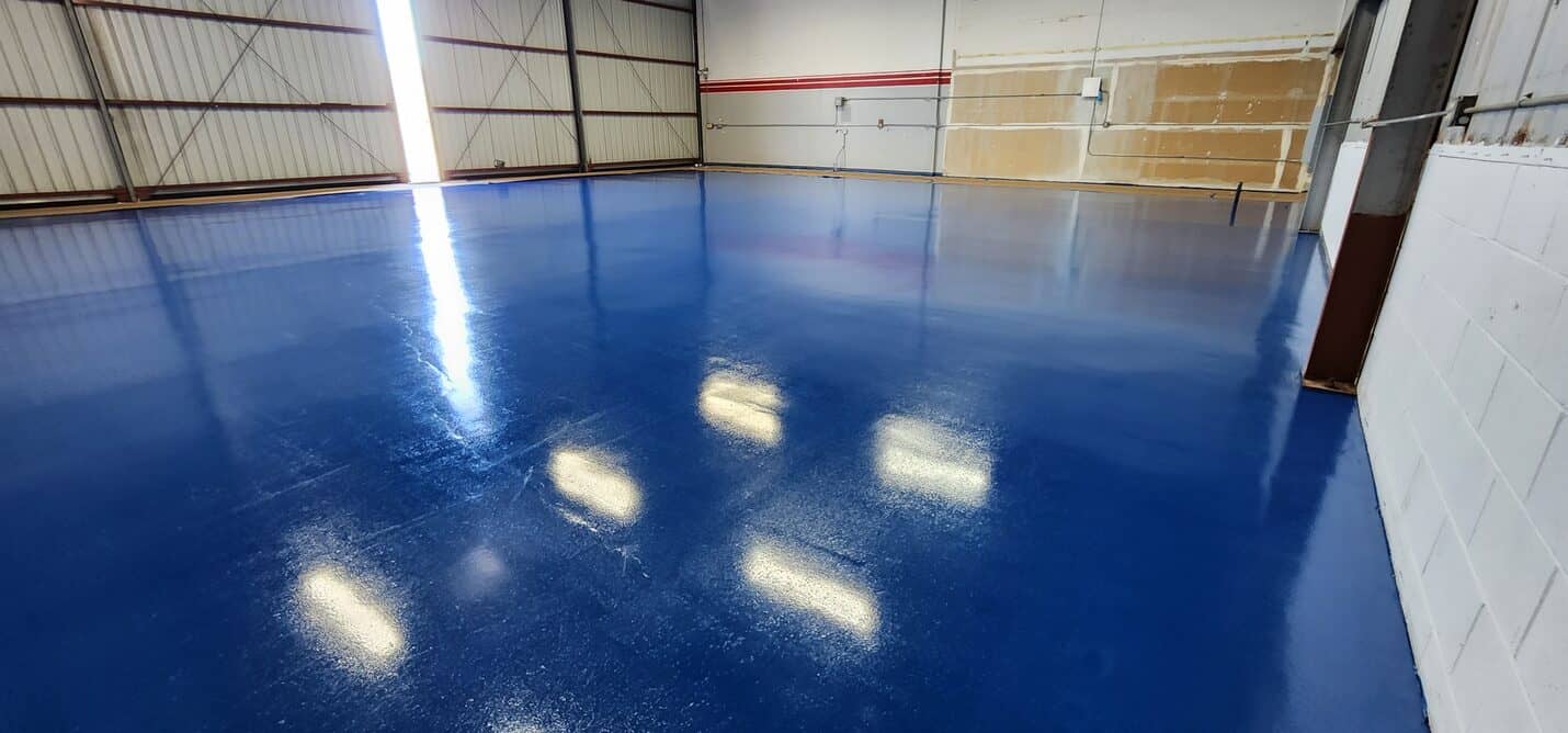 Aircraft hangar slab in Torrance before coating, with saw cut control joints