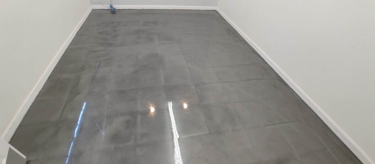 High gloss metallic office floor reflecting the windows