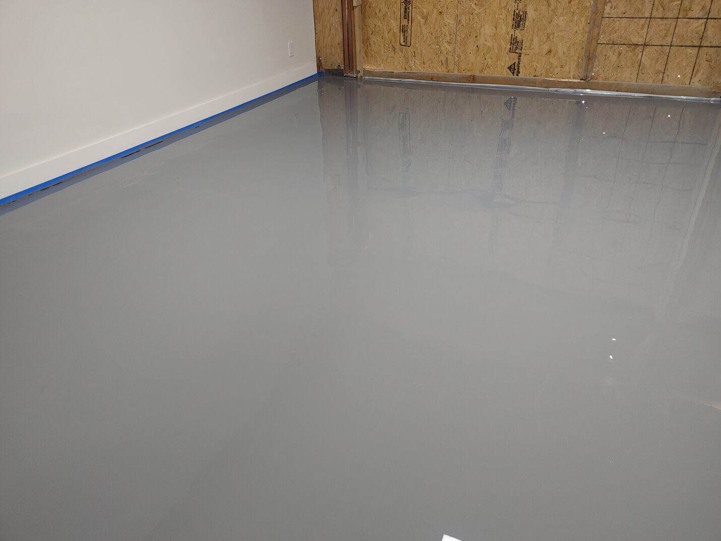 High gloss epoxy floor reflecting the shop windows