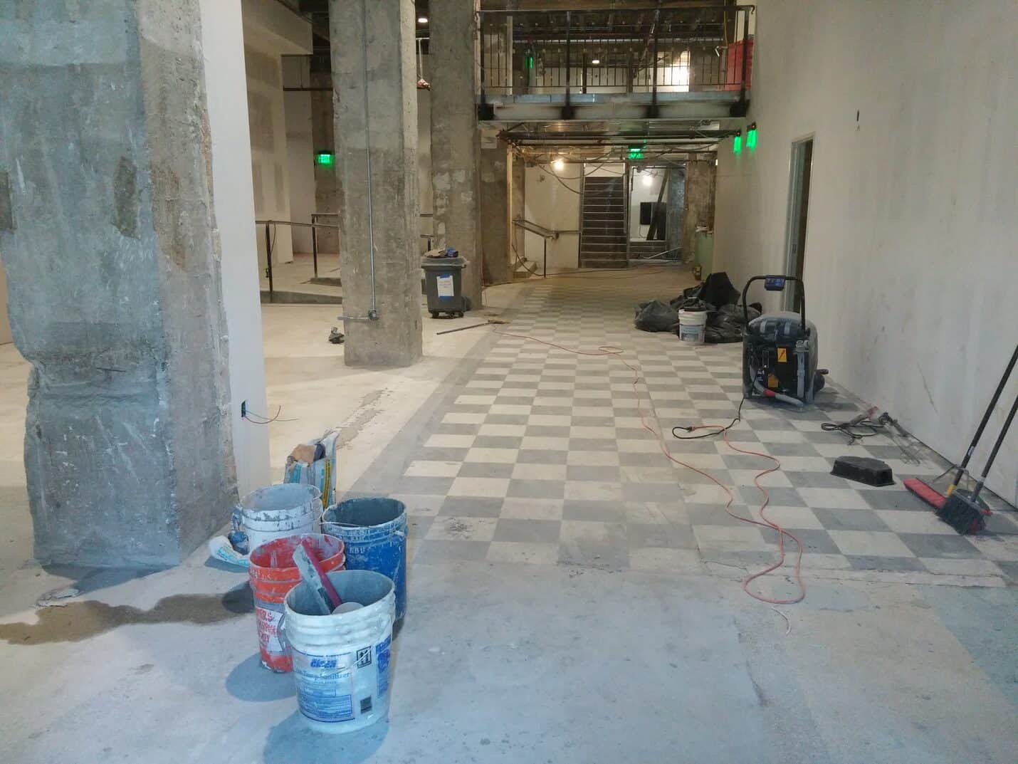 Sections of the checkerboard lost and made good with plain concrete