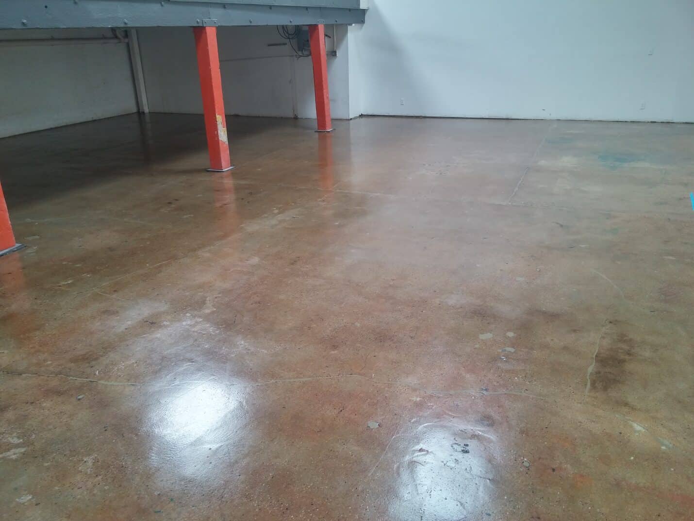 Sealed industrial floor with the crack repairs still visible