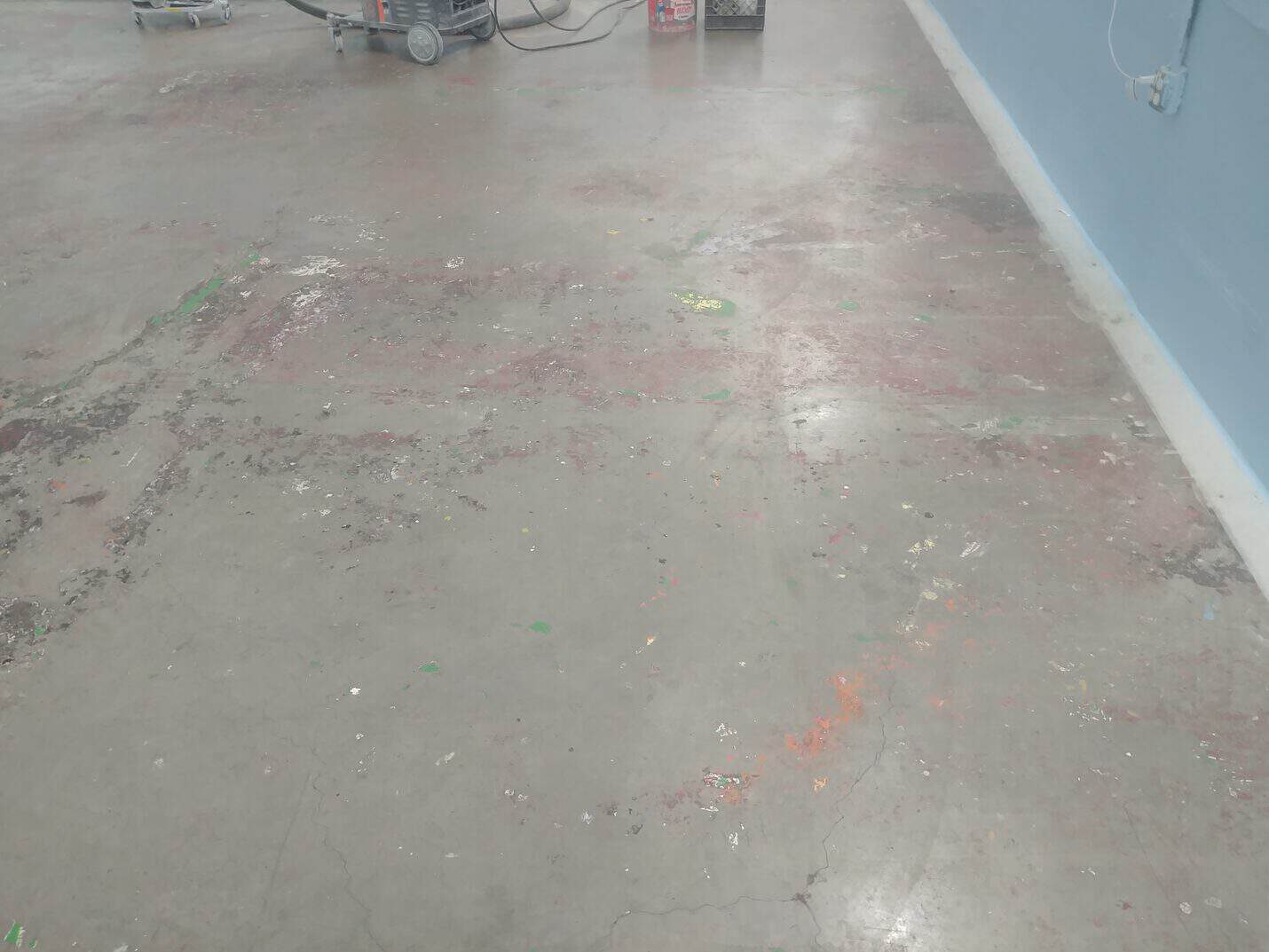 Paint spatter and marks across the kennel floor