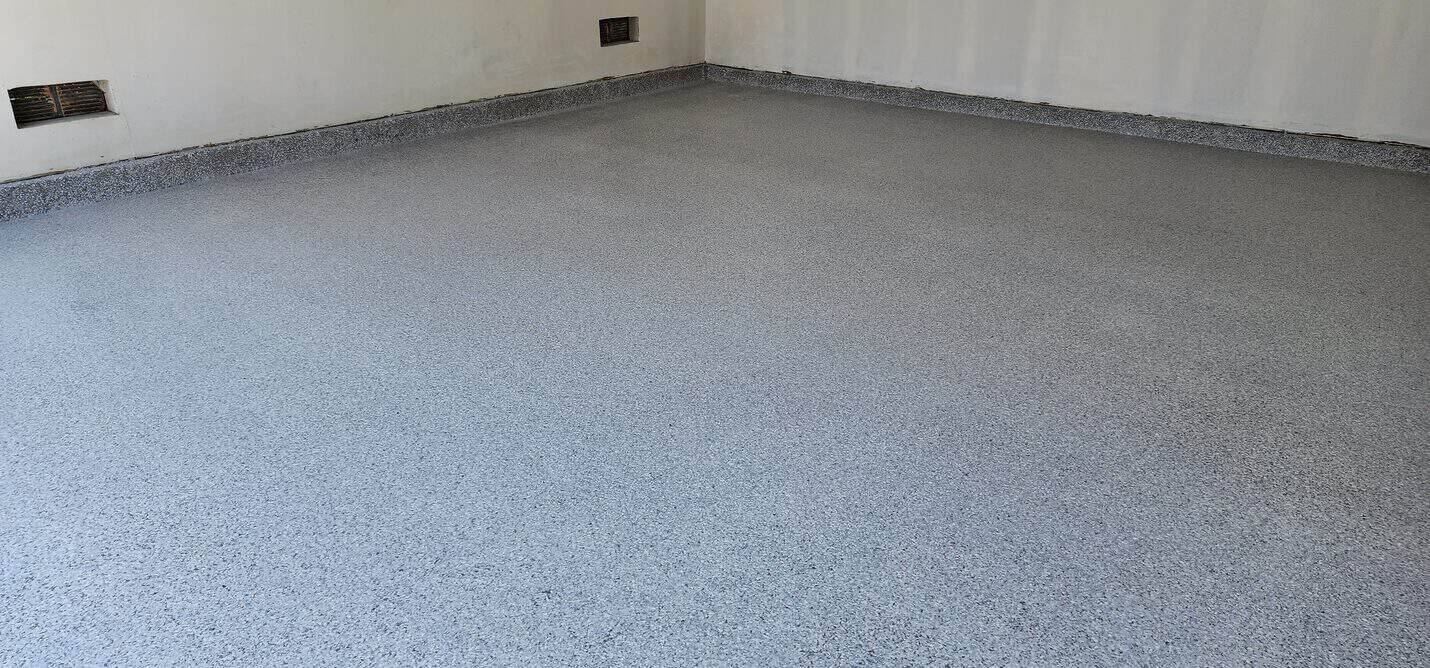 Finished flake garage floor showing the full chip broadcast