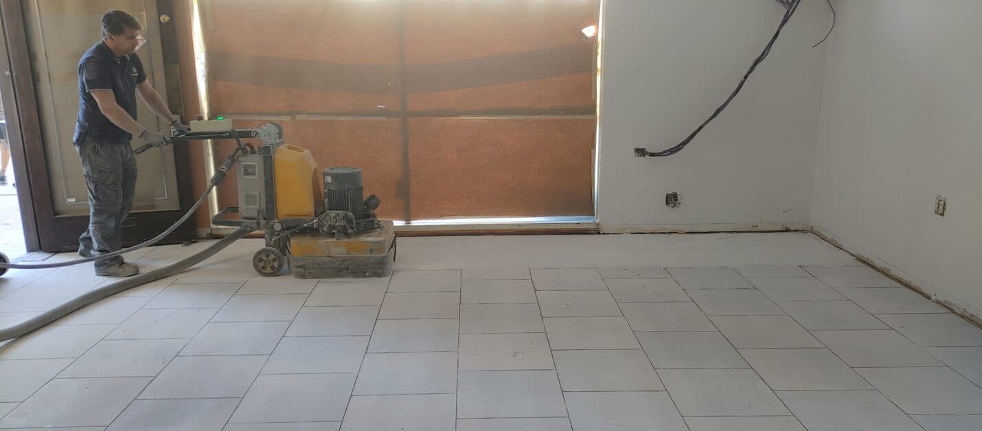 Crew grinding tile adhesive off the salon slab
