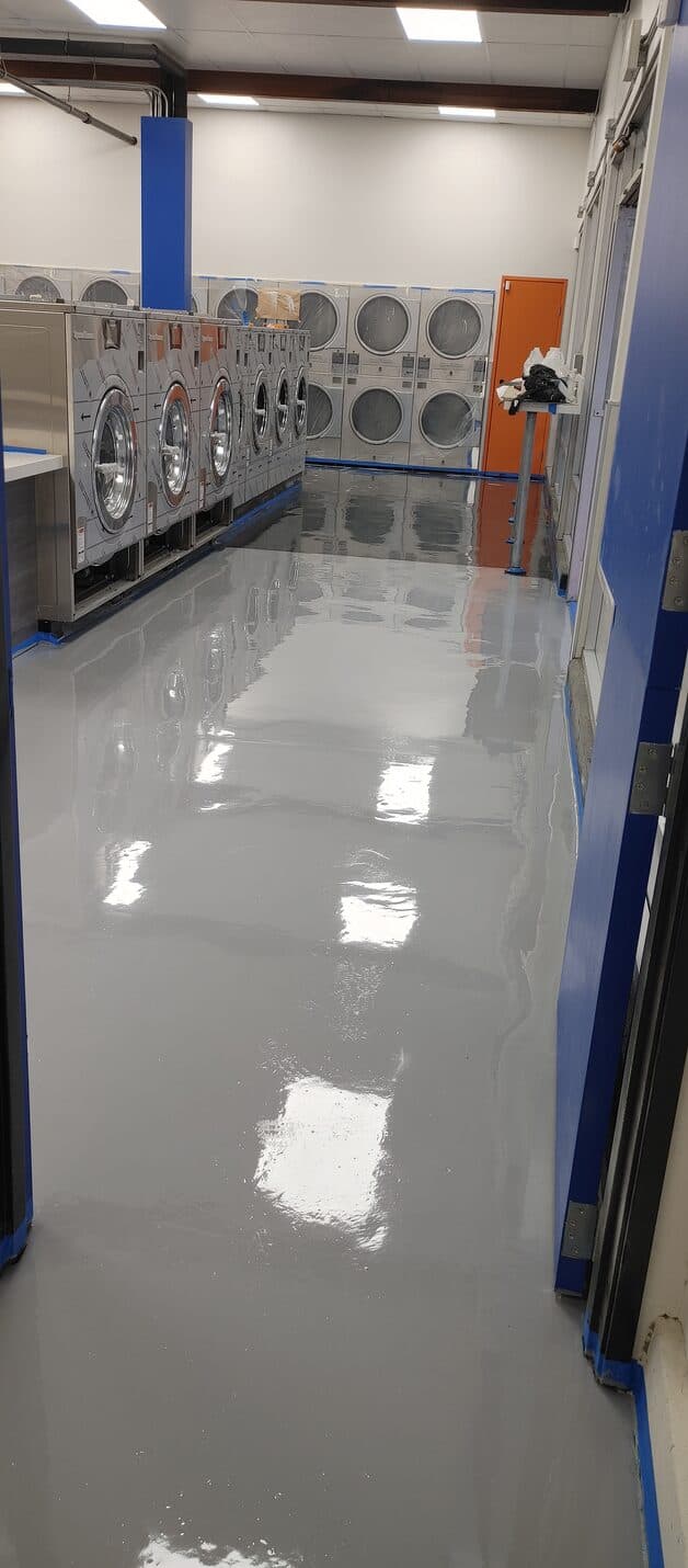 White and silver metallic epoxy floor with blue veining