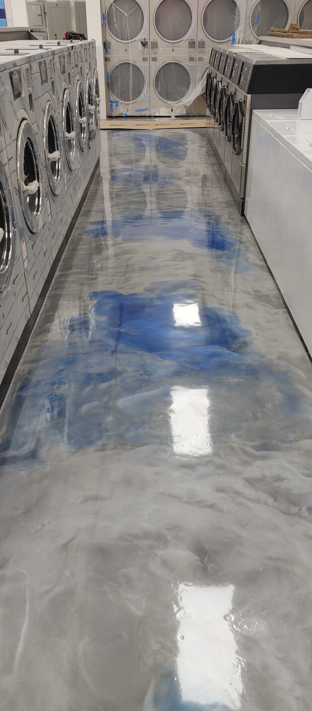 Worn green floor coating in a Long Beach laundromat before work