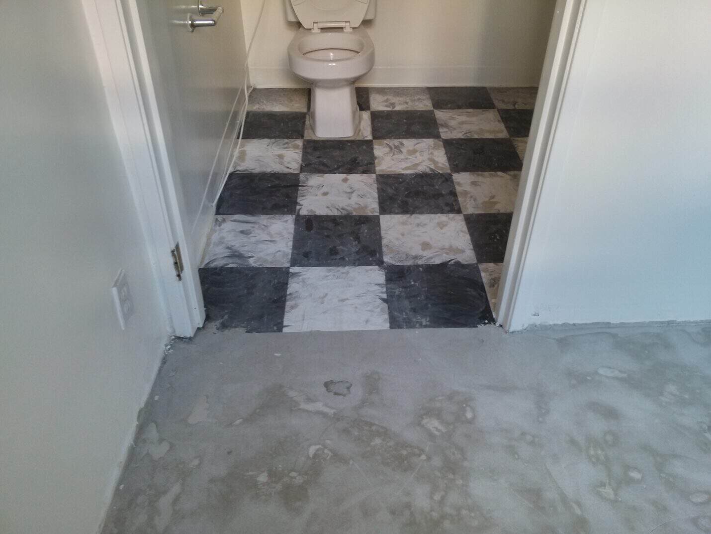 Old black and white checkerboard vinyl in the office restroom