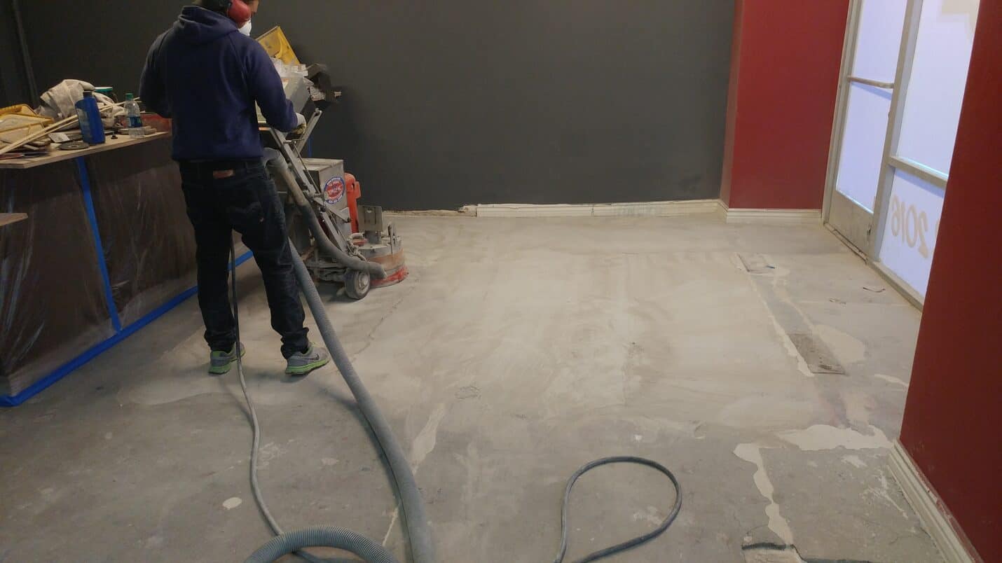 Crew grinding the dining floor with the bar protected