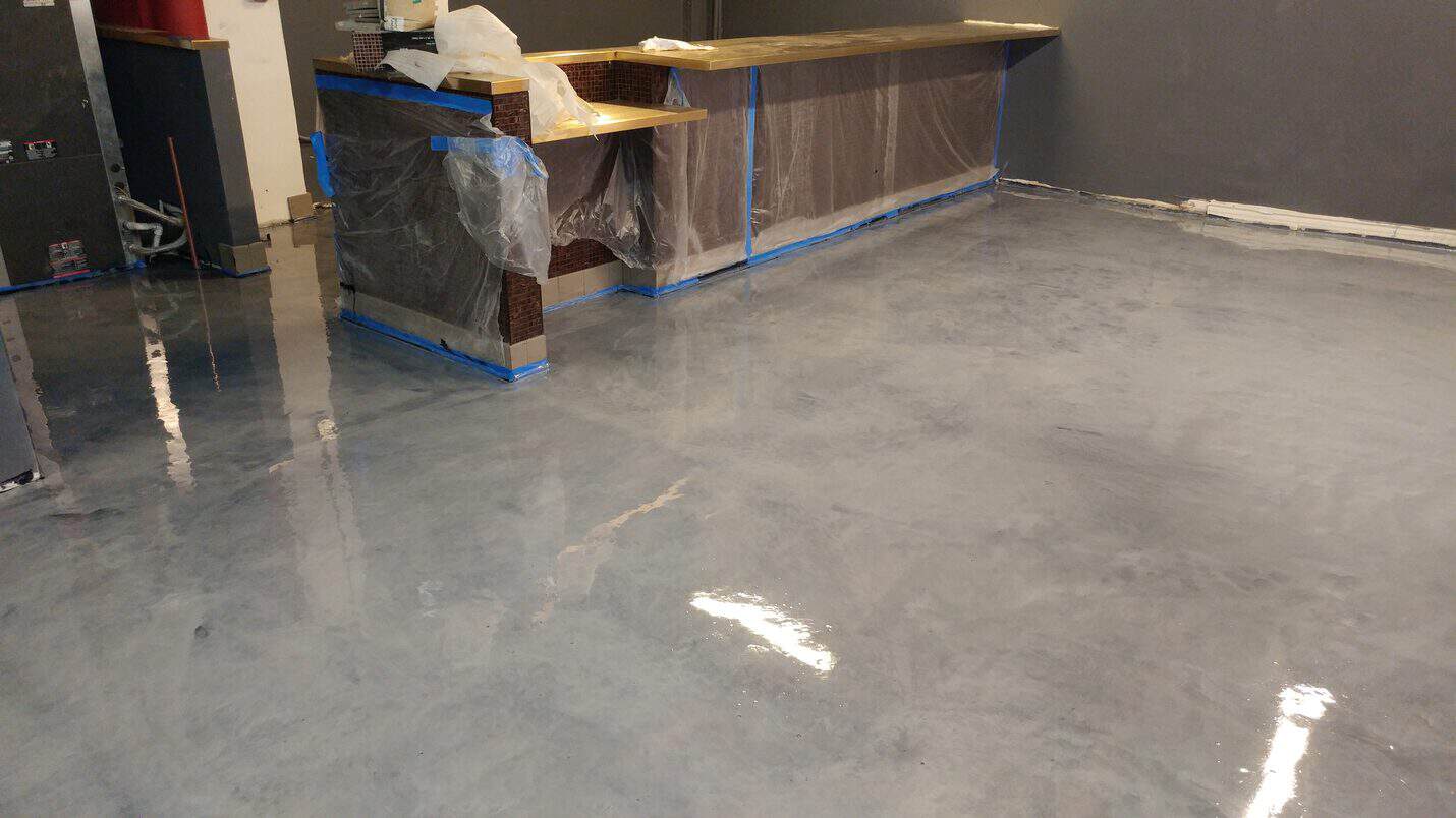 Dark pewter metallic epoxy floor in the finished restaurant