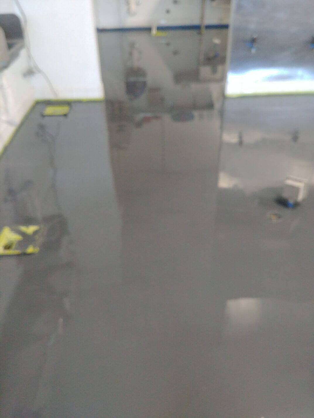 Coved epoxy base meeting the tiled kitchen walls