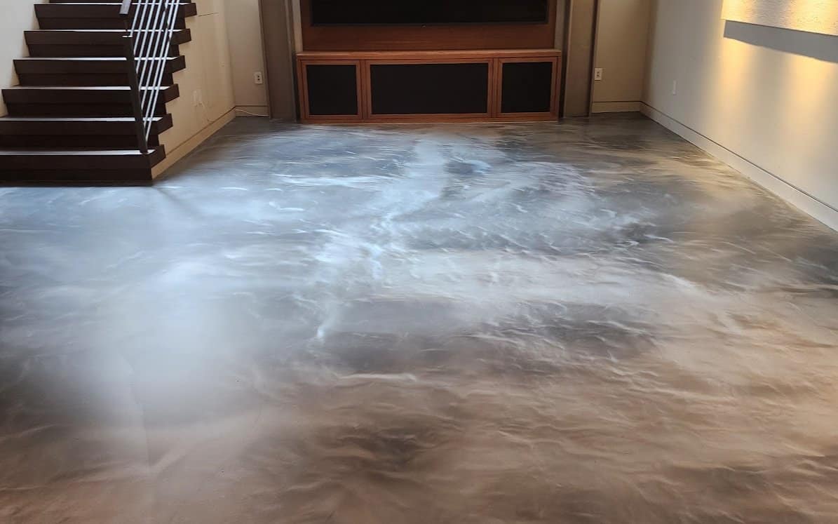 Metallic epoxy floor with a matte finish in the living area of a high-end residence