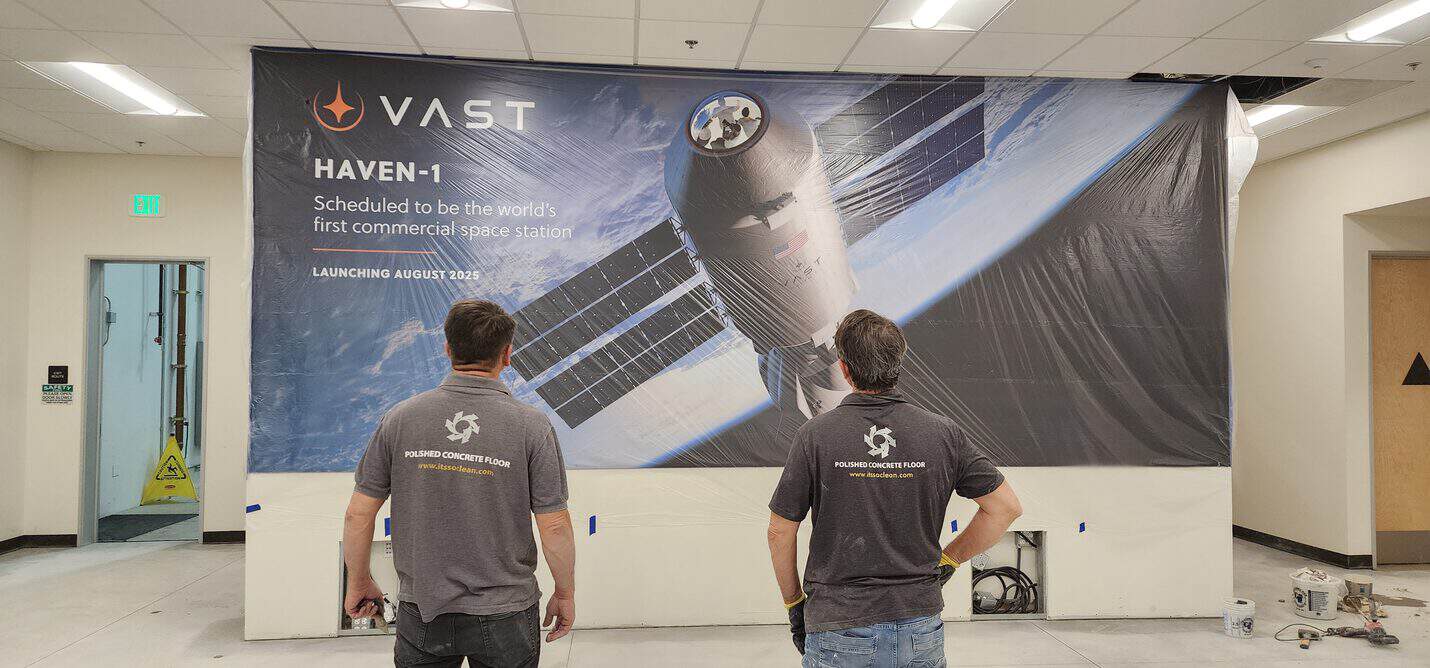 Crew reviewing the floor against the graphics wall, VAST Aerospace Long Beach (4 of 10)